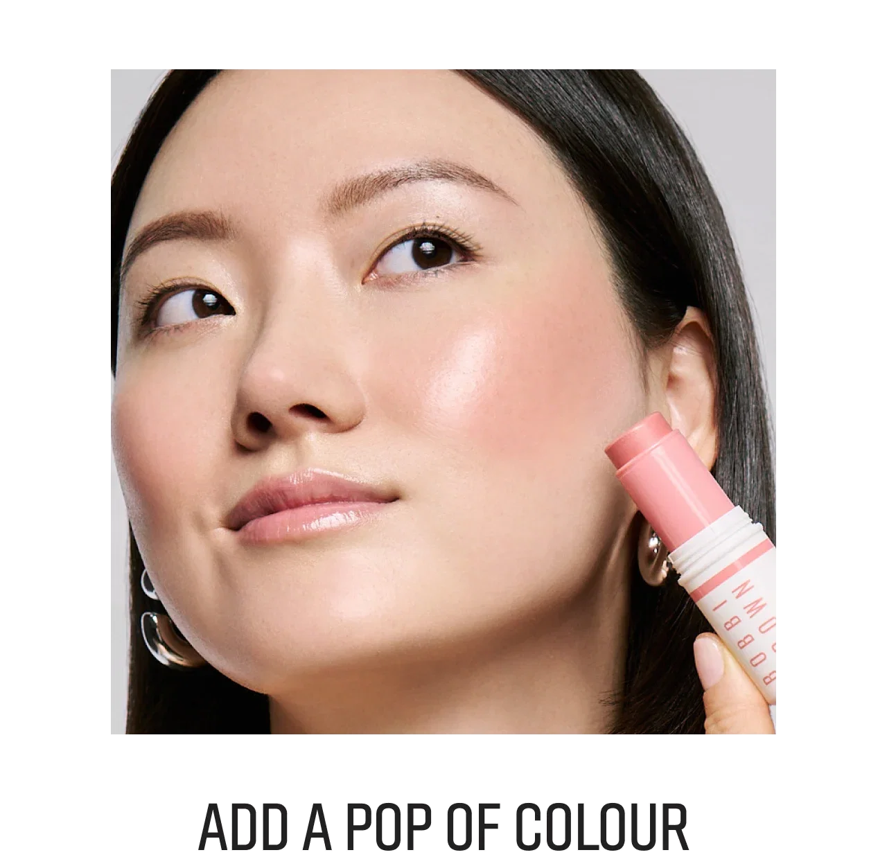 Close-up of a woman applying Skin Enhancer Multi-Stick to her cheek, with title 'Add Some Colour' below.