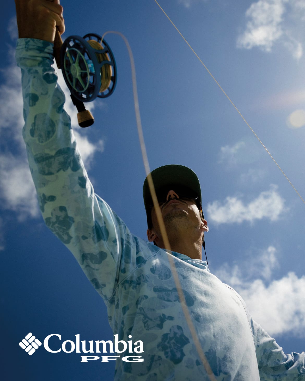 Man is casting a line under a blue, sunny sky.