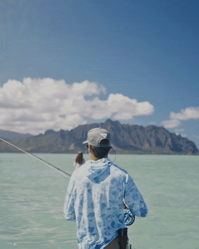 A gif featuring a man fly fishing on a boat in green waters. 