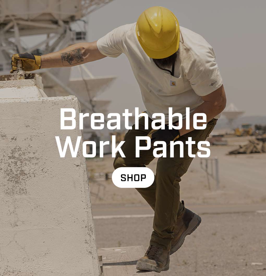 a man working outside in the heat wearing brown work pants.