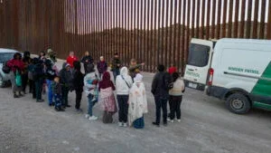 Immigrants wait to be transported by U.S. Border Patrol agents after crossing the U.S.-Mexico border on January 20, 2025 near Sasabe, Arizona.