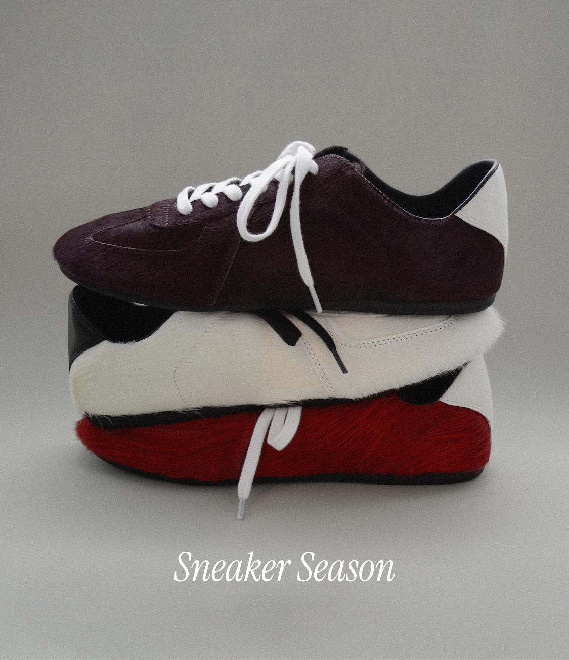 Pile of three ACE sneakers stacked on top of eachother