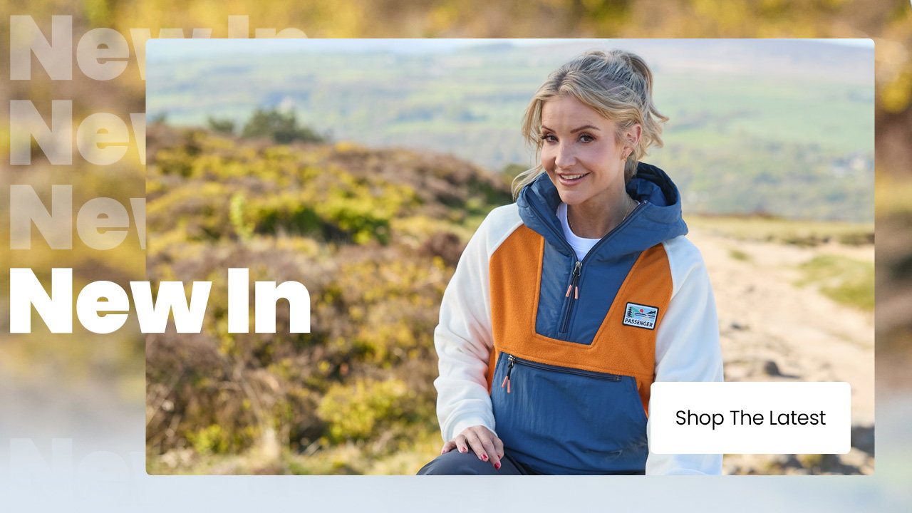 New arrivals outdoor clothing banner with a person wearing a colour-block fleece jacket and a “Shop The Latest” button.
