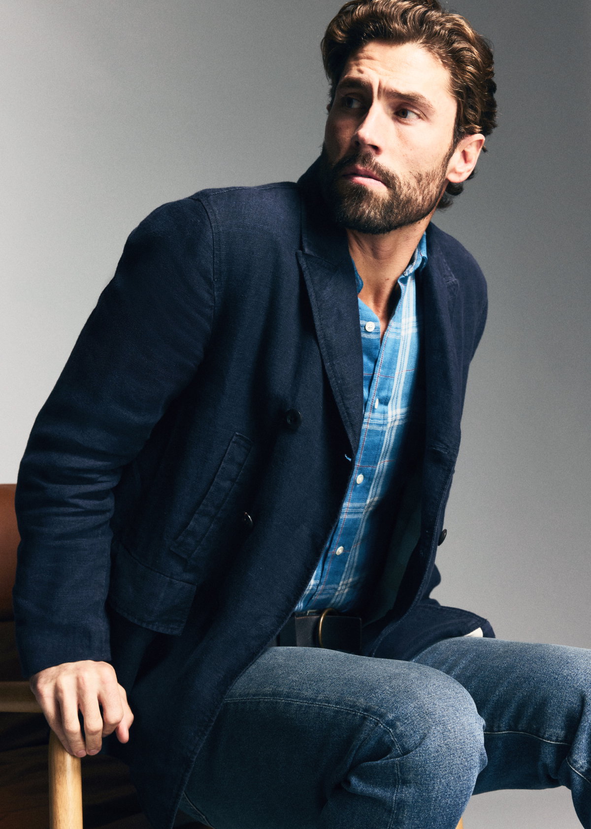 Model wears the peacoat against a grey background.