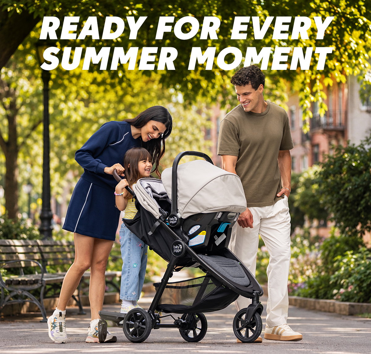 Text ready for every summer moment above a smiling family with a stroller in a sunny park.