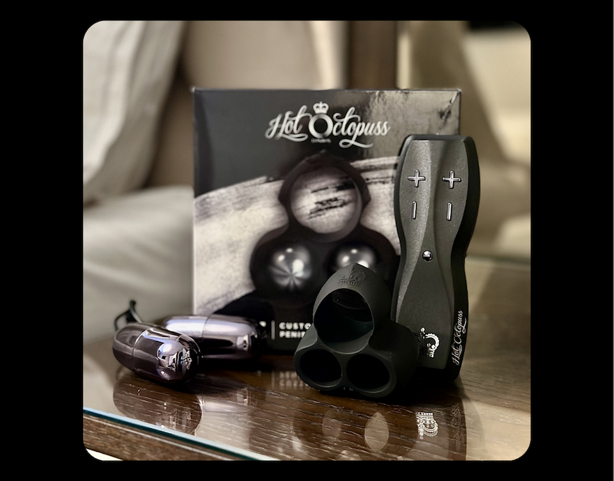 JETT hands-free male masturbator with remote control, silicone sleeve and vibrating bullets displayed in front of the Hot Octopuss product box.