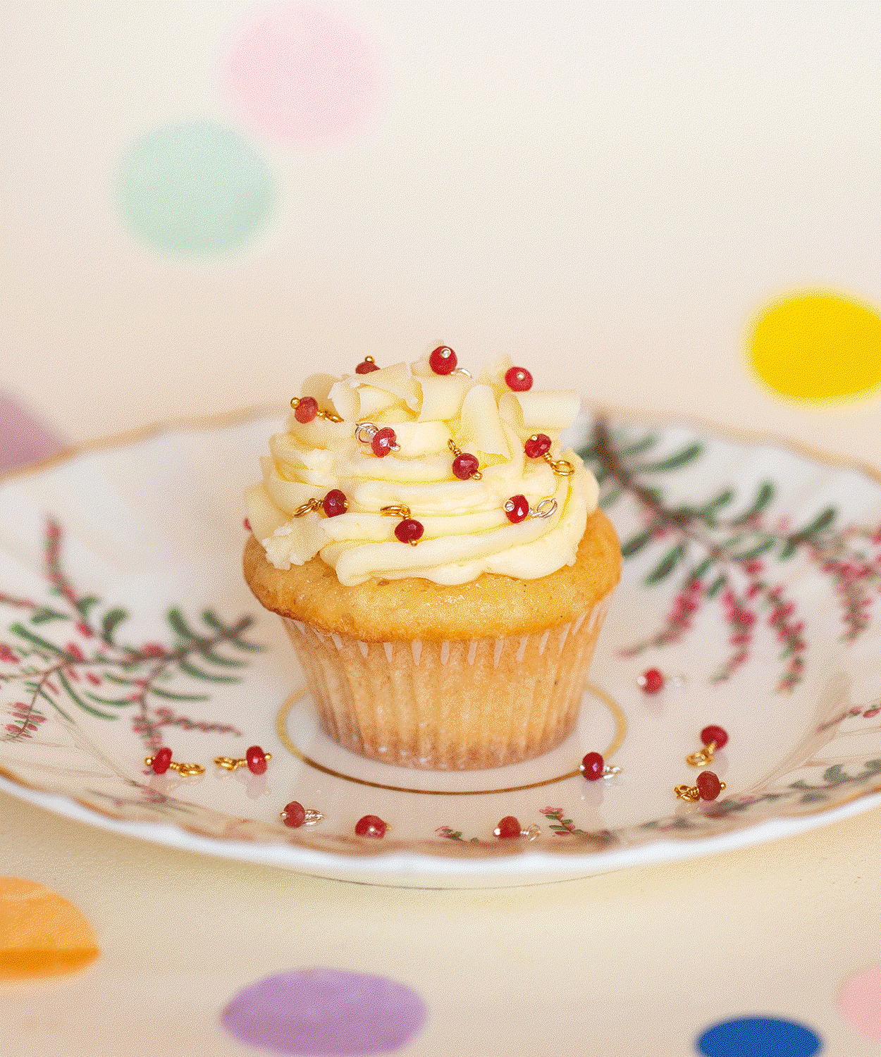 Cupcake decorated with Alex Monroe's limited-edition Ruby Briolettes, created to celebrate 40 years of Alex Monroe.