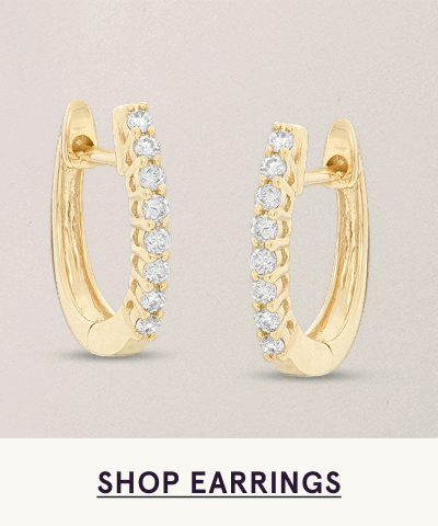 Gold hoops with front face lined with row of close-set diamonds. Get glowing. Click here shop earrings