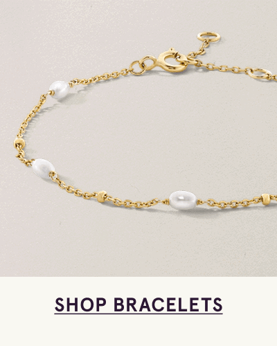 Dainty link gold bracelet with space-out pearls.  Click here to shop bracelets