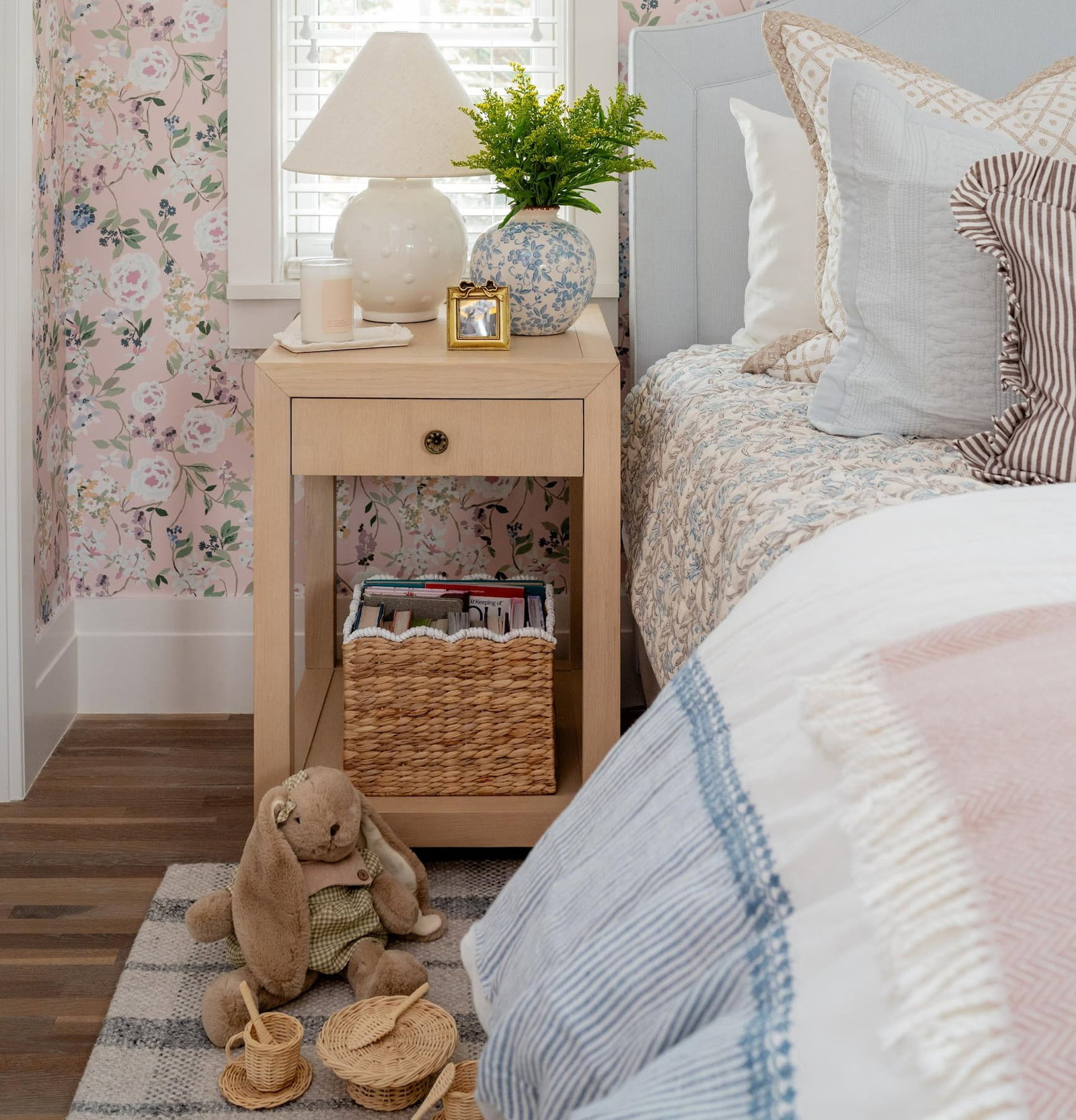 Close up of a wood nightstand layered with decor