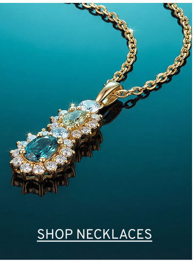 Intricate gold floral pendant with two large blue gemstones surrounded by diamond petals. Click to Shop Necklaces