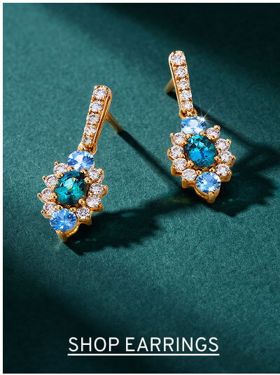 A pair of blue gemstone drop earrings. Click to Shop Earrings