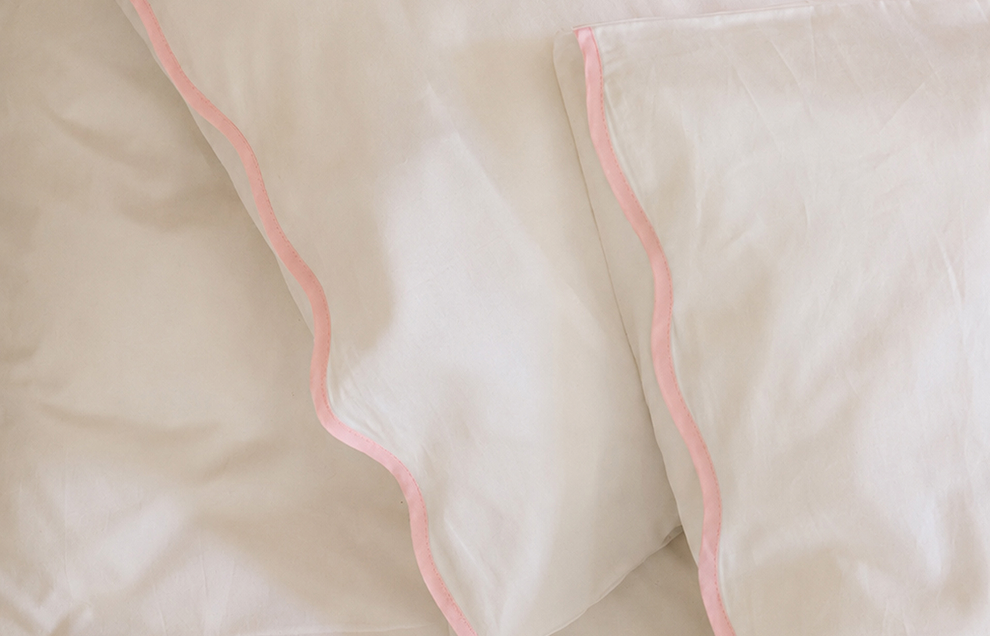 Side of Soft Wave pillow, showing pink wave details on lining