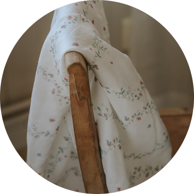 Botanical Berries swaddle draped over chair