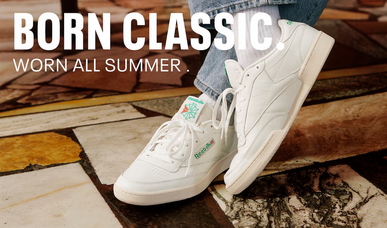 Close-up of Club C 85 Vintage worn indoors. Text reads: “BORN CLASSIC. WORN ALL SUMMER.”