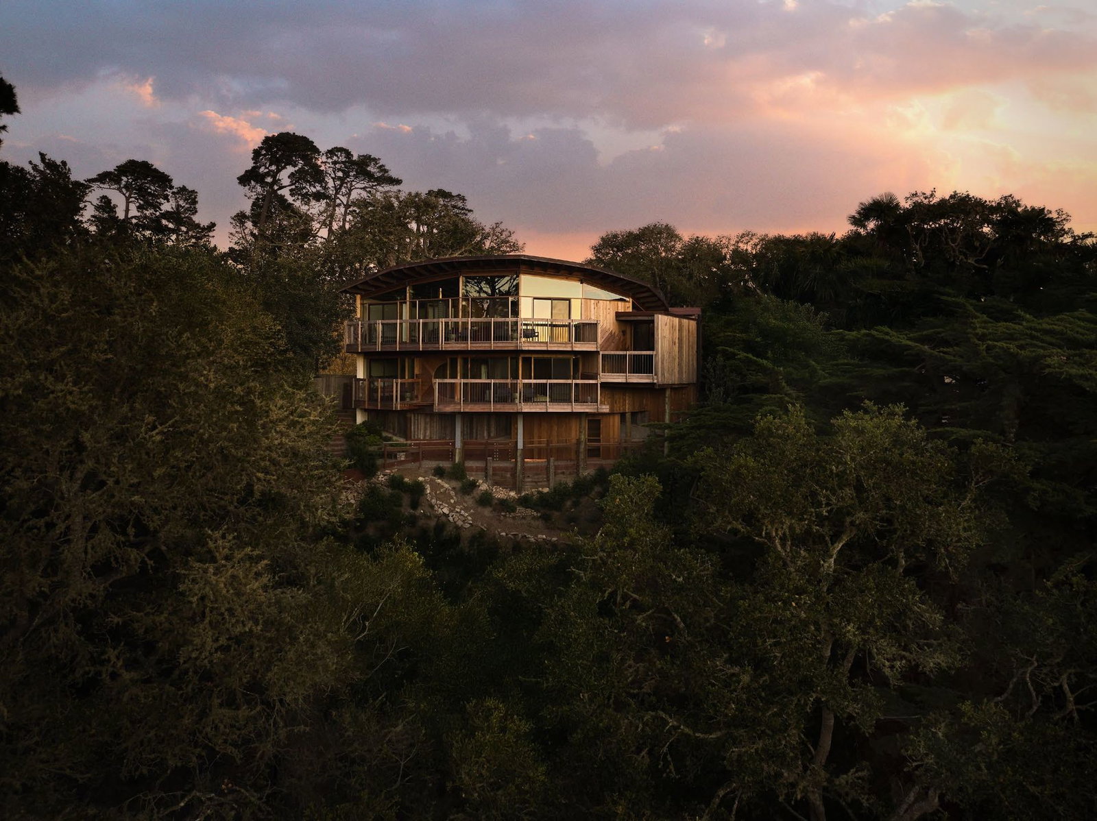 Wood and glass house amid trees