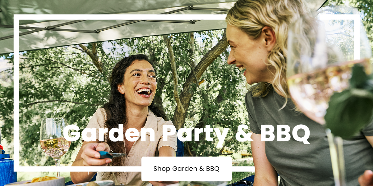 People gathered around a table at a garden barbecue