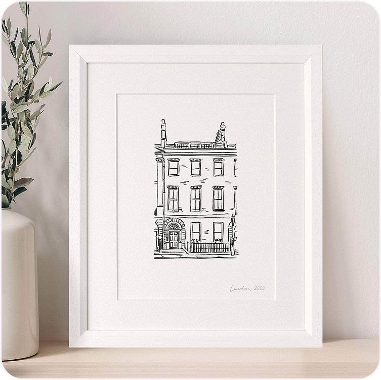 A framed minimalist line art illustration of a terraced townhouse, displayed in a white frame against a soft neutral background