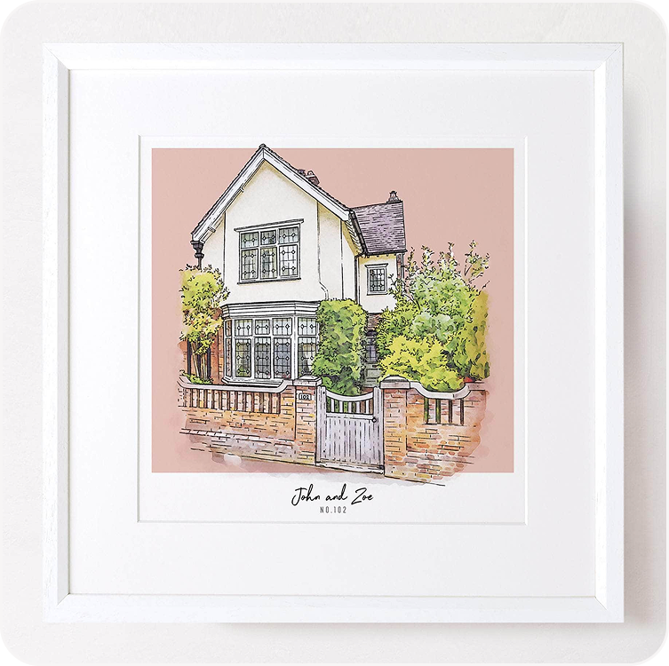 A framed colour block illustration of a detached house with a garden, personalised with the family name, displayed against a soft pink background