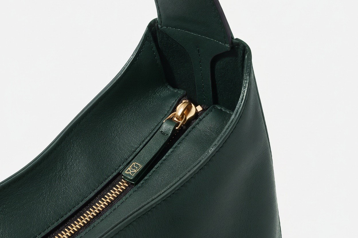 Brass top zip and full-grain leather