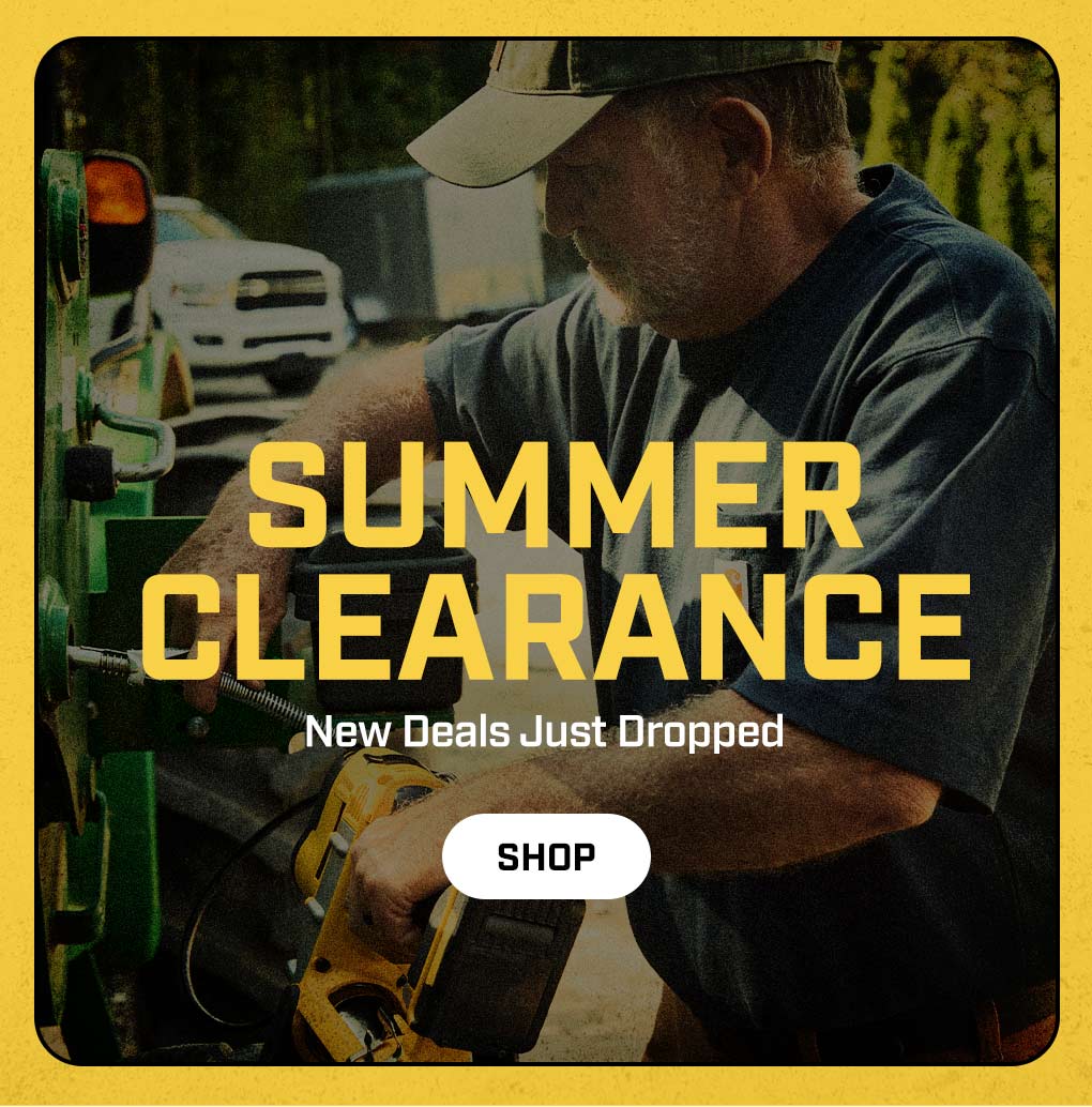 a man wearing a Carhartt t-shirt putting gas in a truck