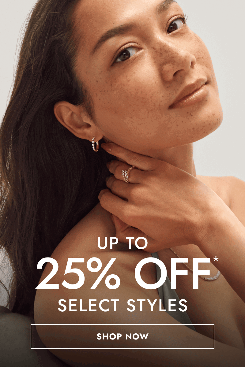 Female model wearing a curved diamond pendant necklace, ring and hoops. Up to 25% OFF select styles. Click shop now.