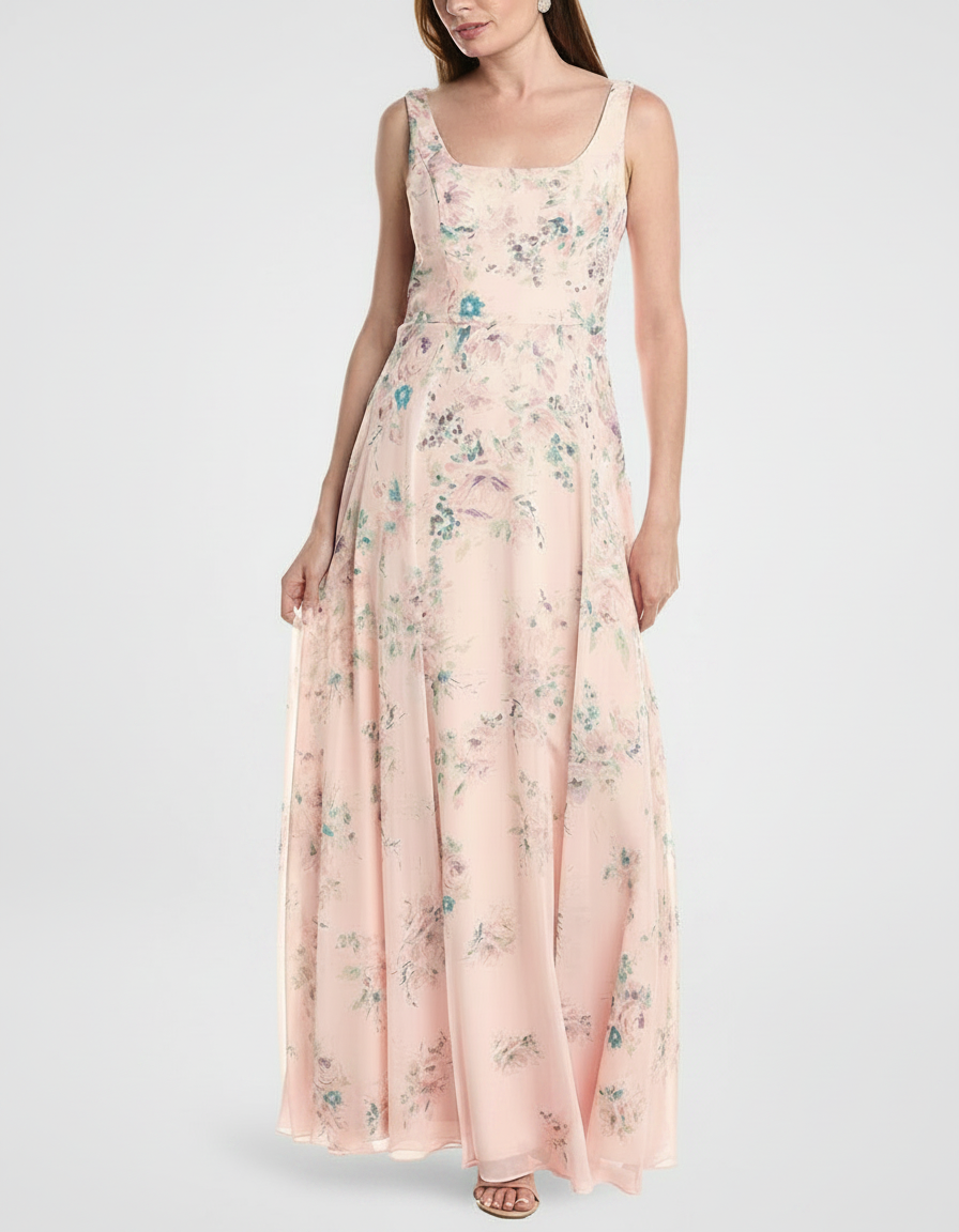 Woman in a long, light pink floral print dress.