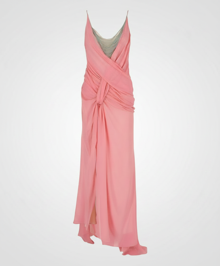 A pink, draped, floor-length gown with spaghetti straps and a high slit.