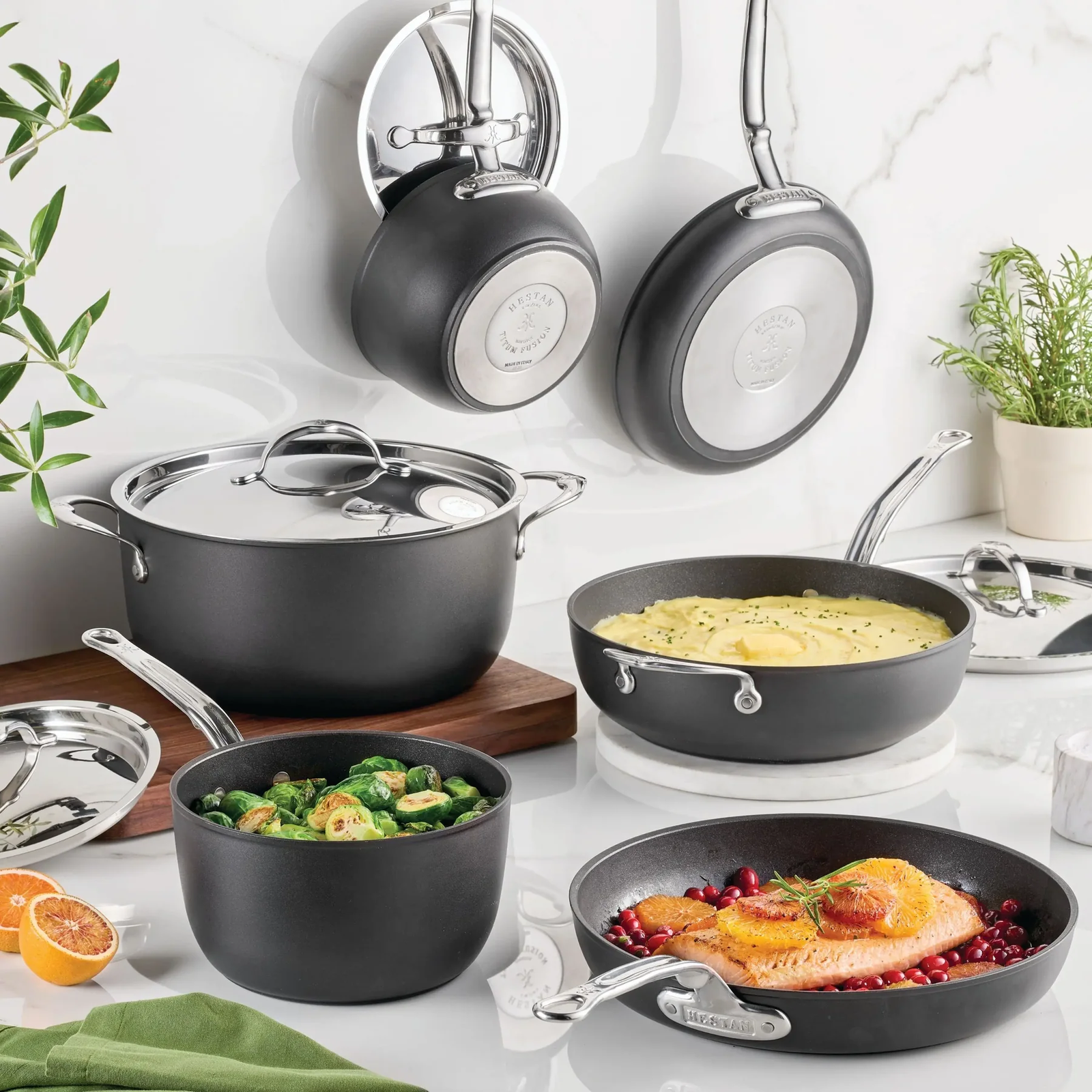 IMG: Food cooked in TITUM Fusion skillet, with maroon background. Text that reads: "Invest in Innovation  TITUM Fusion 20% Off". Made in Italy logo. Hestan logo at the top.
