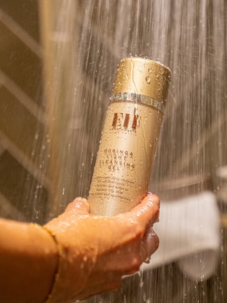 Emma Hardie Moringa Light Cleansing Gel held under running shower water.