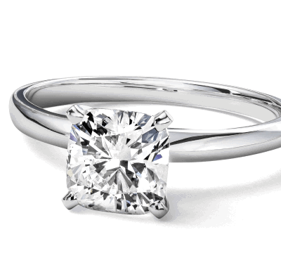 White gold solitaire engagement ring with cushion cut diamond.