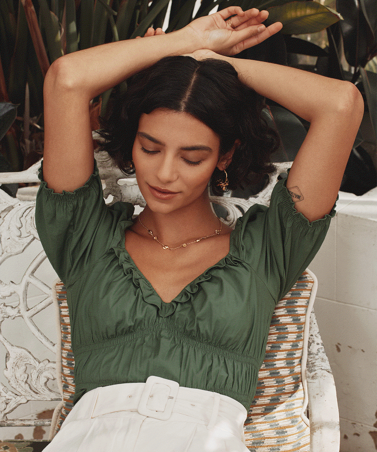 Model wearing delicate gold jewellery, including a necklace and earrings from the Back in Stock collection.
