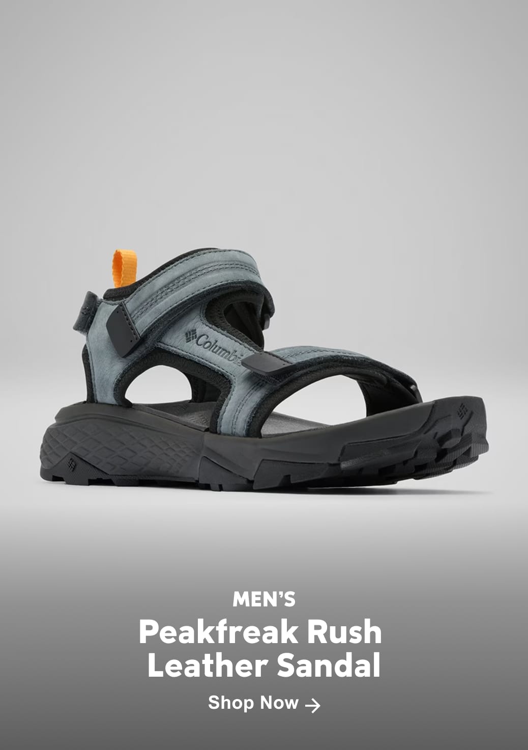 A blue and black sandal with text: Men's Peakfreak Rush Leather Sandal