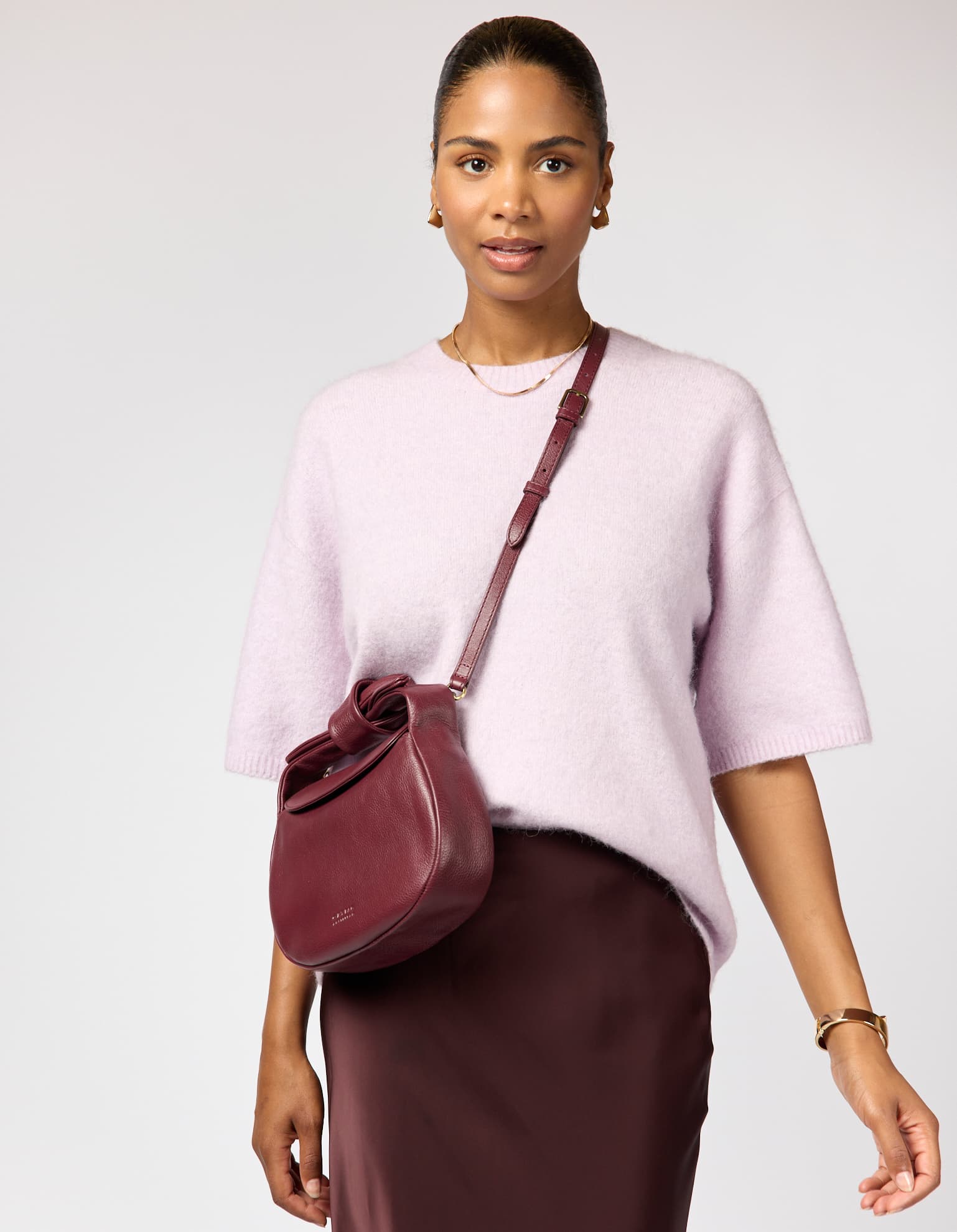 Model wearing Coco bag in Dark Cherry