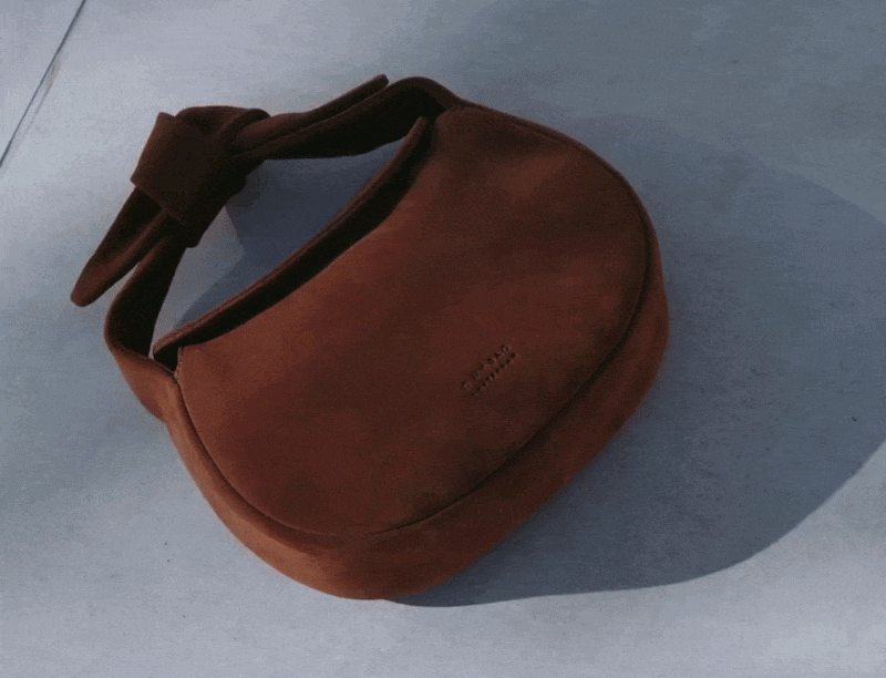 Coco in Cognac Suede lying on the floor