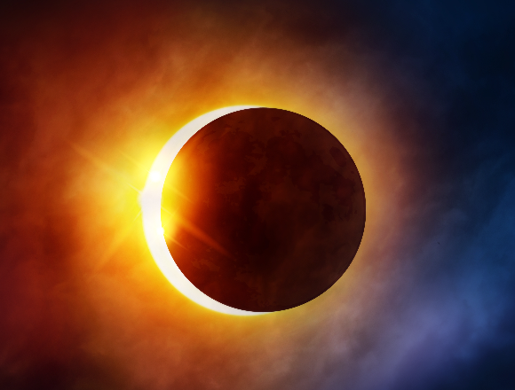total solar eclipse, showing a solid black moon perfectly centered and surrounded by the glowing white light of the sun's corona against a dark sky