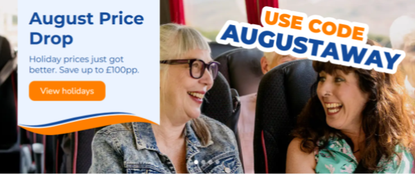 Two ladies smilling at each other on a coach tour