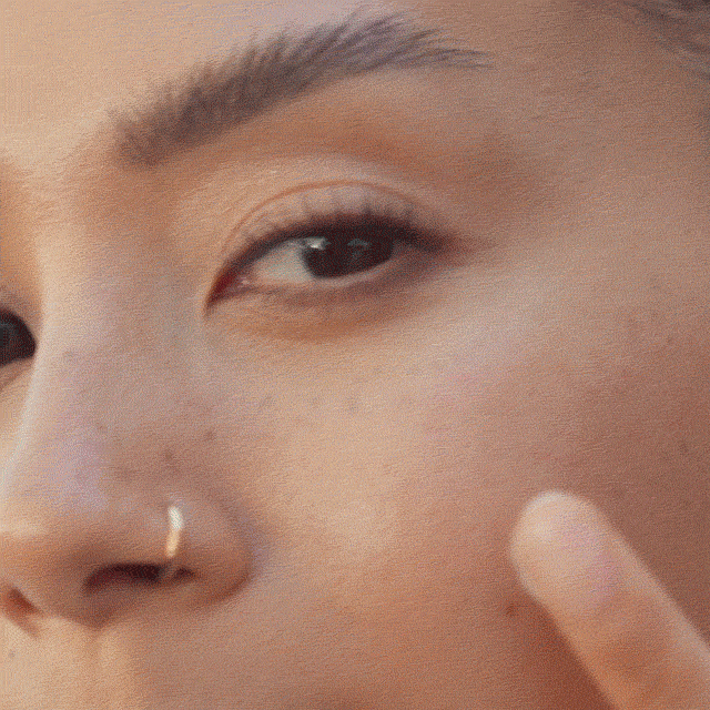 Close-up of Zara Findlay applying the new Vitamin Enriched Face Base+ to her face.