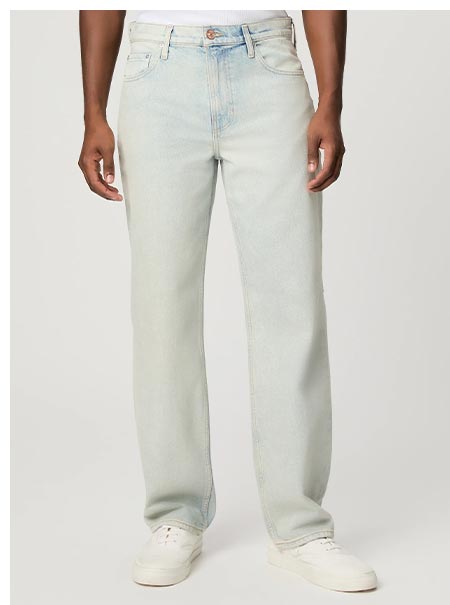 A man's legs wearing light blue wash vintage inspired denim jeans.