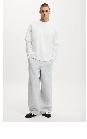 Man wearing white sweatshirt and gray sweatpants