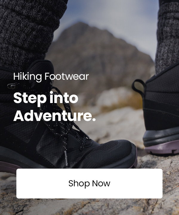 Black Salomon hiking boots standing on rocky mountain terrain with the text “Walking & Hiking Footwear. Step into Adventure.” and a “Shop Now” button.