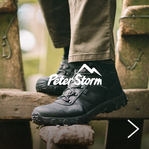 Black Peter Storm walking boots worn on a rustic wooden footbridge, showcasing durable construction and outdoor comfort.