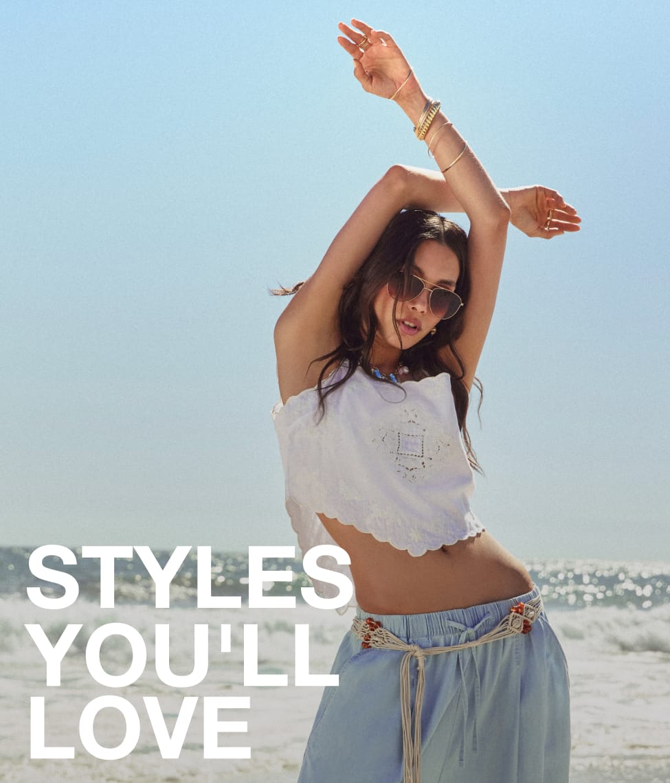Model wearing a brown co-ord set with loose trousers and an off-shoulder top, styled with sandals, bangles, and a headscarf, sitting on a pouffe with “25% Off Your Personalised Edit” promotional text.