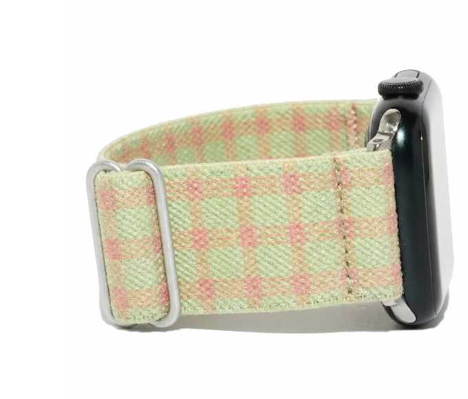 Close-up of the Retro Apple Watch band, a green and pink plaid design.