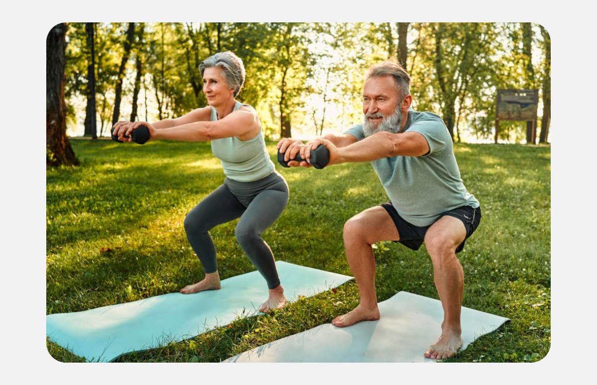 An image of an elderly man and women participating in resistance training in the park.