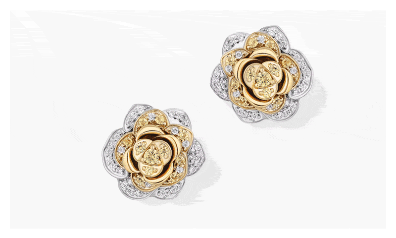GIF featuring two-tone rose-shaped stud earrings with small diamond details, white gold bangle bracelet and sun-shaped pendant.