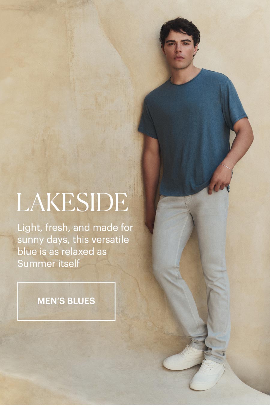 Lakeside - Light, fresh, and made for sunny days, this versatile blue is as relaxed as Summer itself. Shop Men's Blues. Featuring a man wearing a blue tee with a pair of light wash jeans, standing against a stone beige wall.
