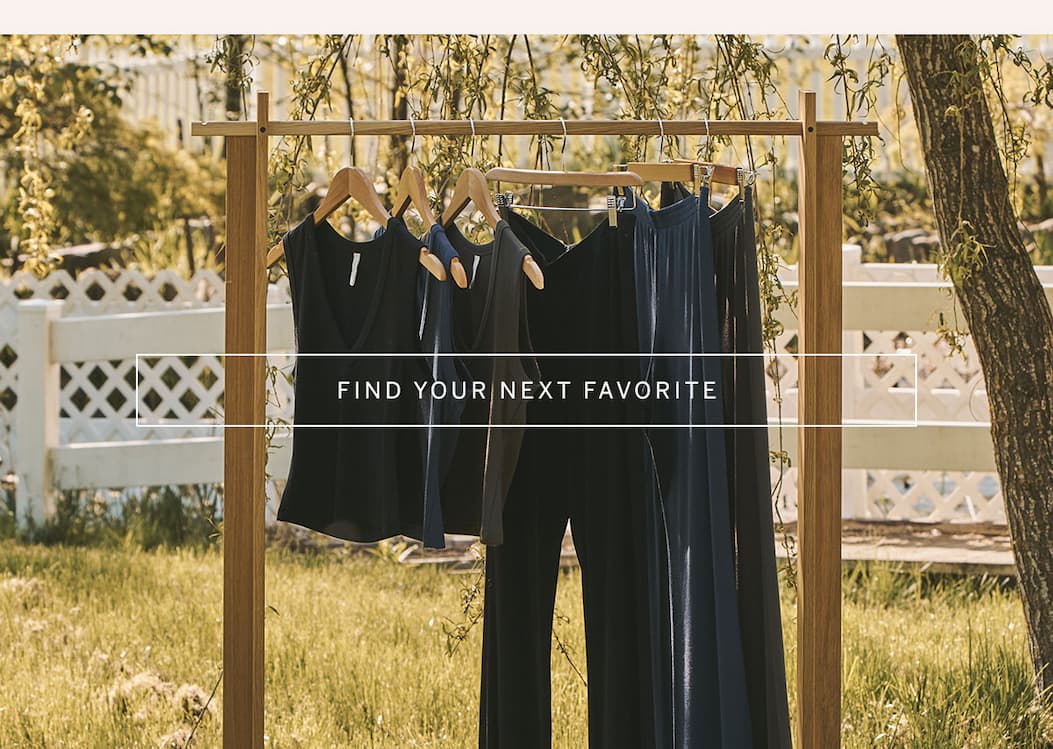 Outdoor clothing rack featuring everyday essentials in navy and black. CTA: “Find Your Next Favorite.”