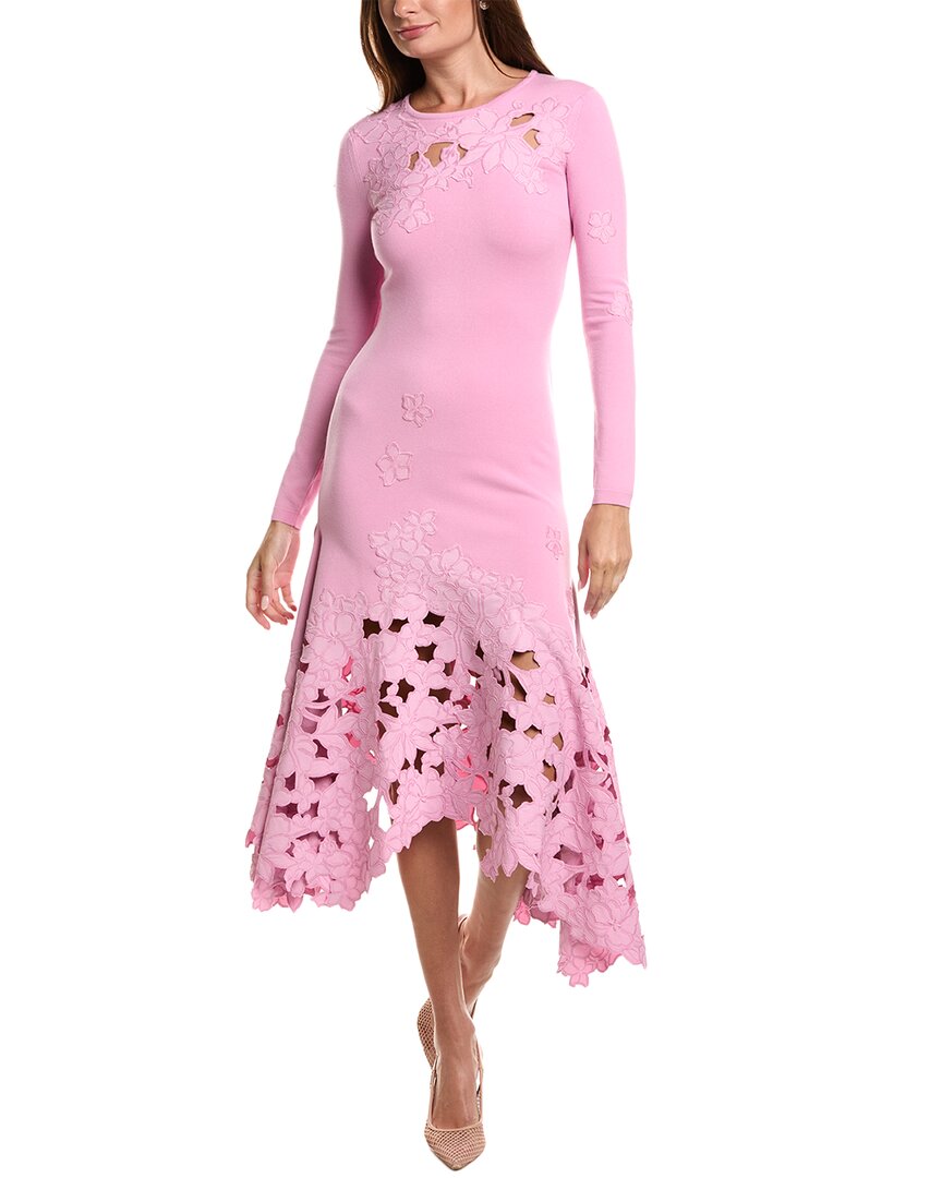 Woman in a black dress with a floral skirt and black heels.