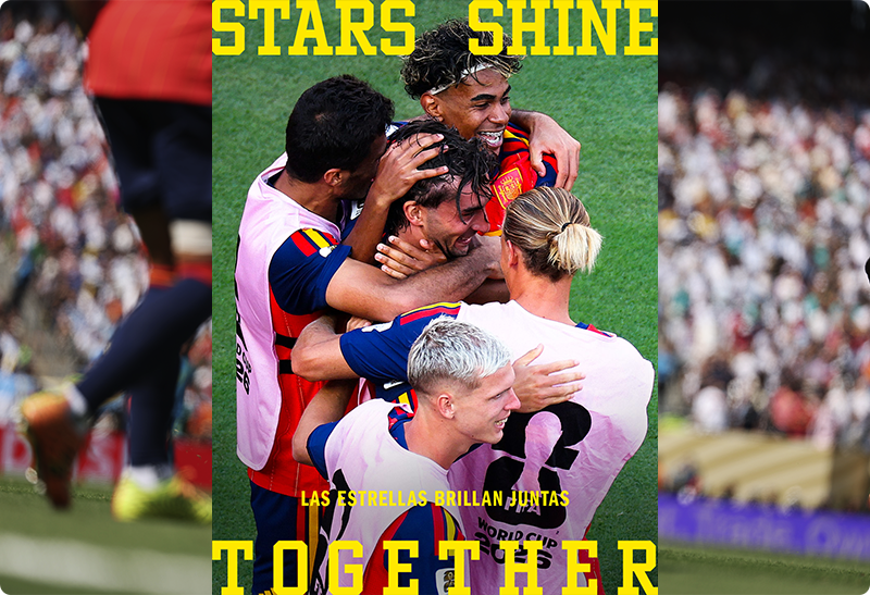 Football players in colourful kits embracing after a goal with a blurred crowd and promotional text reading 'Stars Shine Together'